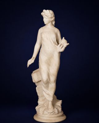 a white marble statue of a woman holding a bucket
