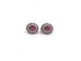 une paire de boucles d'oreilles à clous en rubis et diamants sur fond blanc
