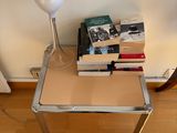 a glass table with books and a lamp on it