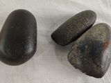 two rocks sitting on a table next to each other
