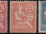 four different postage stamps with a woman sitting on a bench