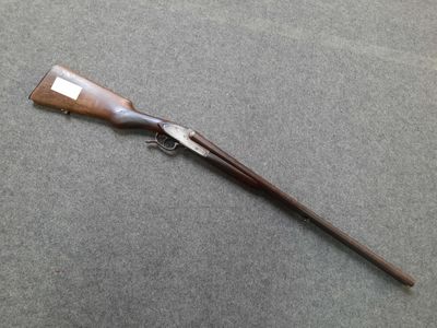 a rifle with a wooden handle on a gray surface