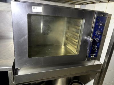 a stainless steel oven with a glass door in a kitchen