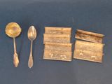 a lot of silver spoons and spoons on a table