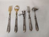 five forks, a spoon, and a spoon rest on a table