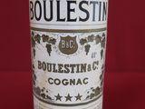 an old bottle of bourbon sits on a red surface