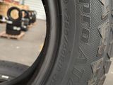 tire tread of a car in a warehouse with other tires in the background