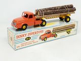 a toy truck with a large load of logs on the back of it