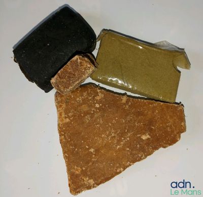 three bars of soap sitting on top of each other on a white surface