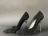 pair of black sued high heel shoes with gold metal heels
