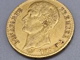a close up of a gold coin on a gray surface