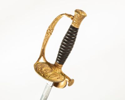 an old sword with a gold handle on a white background