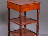 a small wooden table with three shelves on top of it