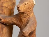 carvings of a bear and a bear cub on a tree trunk