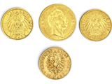 un ensemble de quatre souverains d'or, représentant notamment une tête de lion et une tête de lion
