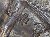 a close up of a metal object with a cross on it