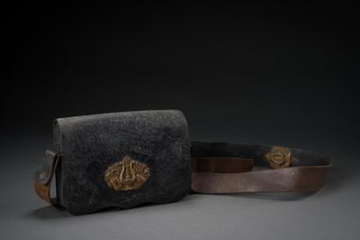 pair of black and brown leather purses on a grey surface