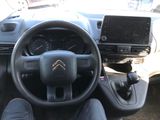 the interior of a car with a steering wheel and dashboard controls