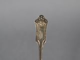 an antique silverware spoon with a flower design on it