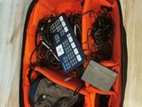a suitcase filled with electronics and other items on the floor