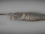 a fish shaped fishing hook with a hook attached to it
