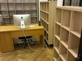 a desk with a computer on it in a room