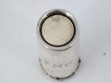 a close up of a silver cup on a white surface