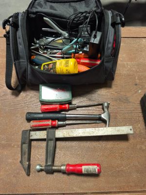 a black bag with tools in it on a table