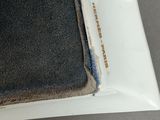 a white plate with a black cloth on top of it