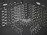 many forks and spoons arranged in the shape of a heart