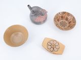 three bowls, a teapot, and a teapot on a white surface
