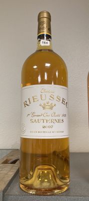 a bottle of wine sitting next to a glass of wine