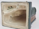 a ceramic sculpture of a speaker on a white surface