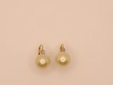a pair of pearl and diamond earrings