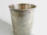 a silver cup that is sitting on a table