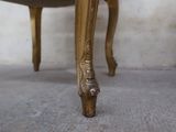 a chair that has a gold finish on it