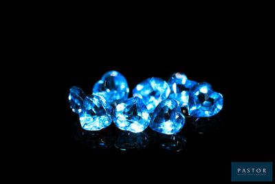 a group of blue diamonds on a black surface
