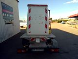 a white truck with a red stripe on the back of it