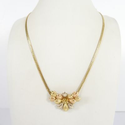 a gold necklace on a mannequin mannequin torso