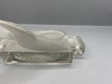 a glass sculpture of a bird on a stand