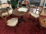 several chairs and a table in a living room with a red rug