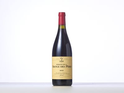 a bottle of red wine sitting on top of a table