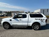 a white pick up truck parked in a parking lot