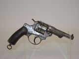a gun that is sitting on top of a glass stand