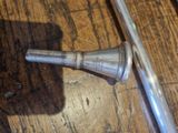 a silver object on a wooden table next to a baseball bat