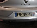 the rear end of a silver car with a number plate on it