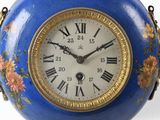 a blue and gold clock with roman numerals on it