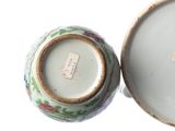a small vase with a lid sitting on a table