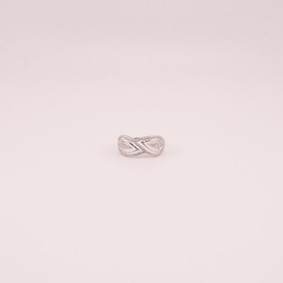 gros plan d'une bague en argent sur une surface blanche
