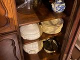 a wooden cabinet with many plates and bowls on it